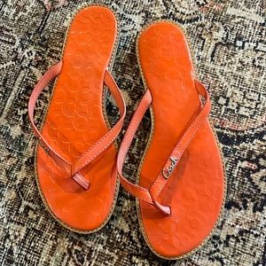 Orange patent leather coach flip flops
